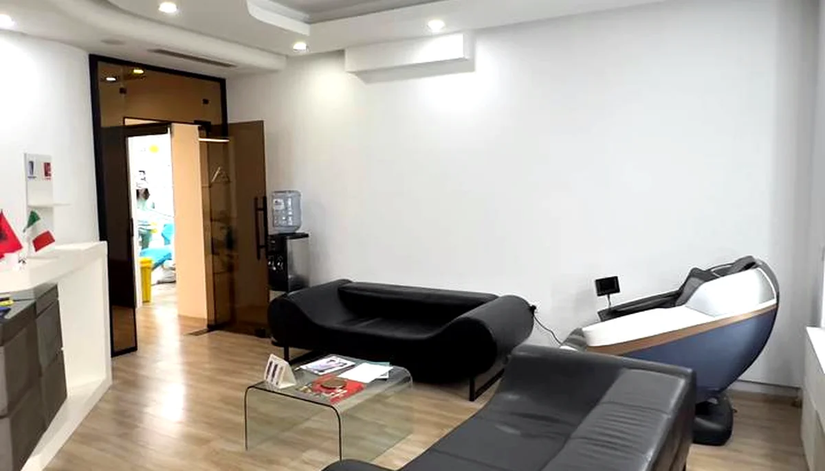 Reception and waiting room with leather sofas at our clinic in Tirana